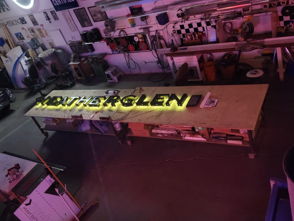 HEATHERGLEN halo-lit LED letters under test on the shop bench